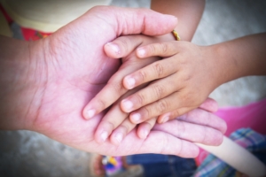 Hand of an elderly holding hand of younger Hand of an elderly holding hand of younger